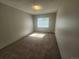 Bedroom featuring neutral carpet, window with blinds, and a wall mounted air conditioner at 9650 Huron St # 23, Thornton, CO 80260