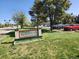 Prairie Green Condominiums entrance sign with landscaping and visitor parking on a sunny day at 9650 Huron St # 23, Thornton, CO 80260