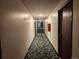 Condo hallway with patterned carpet, unit doors, and access to stairs and an exit at 9650 Huron St # 23, Thornton, CO 80260