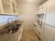 Functional kitchen with white appliances, double sink, and light colored cabinets at 9650 Huron St # 23, Thornton, CO 80260