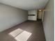 Vacant living room showcasing neutral carpet, painted walls, and some built-in cabinetry at 9650 Huron St # 23, Thornton, CO 80260