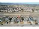 Aerial view of the property showcasing neighborhood, nearby green spaces, and mountain views at 1164 English Sparrow Trl, Highlands Ranch, CO 80129