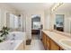 Bright bathroom with a double vanity, a soaking tub, and a glass-enclosed shower at 1164 English Sparrow Trl, Highlands Ranch, CO 80129