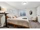 Serene bedroom with natural light, a comfortable bed, and a stylish accent chair at 1164 English Sparrow Trl, Highlands Ranch, CO 80129