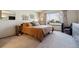 Bright bedroom featuring a neutral palette, carpet, and a large window overlooking the outdoors at 1164 English Sparrow Trl, Highlands Ranch, CO 80129