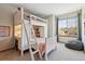 bedroom featuring bunk beds with desk and ladder, and a large window at 1164 English Sparrow Trl, Highlands Ranch, CO 80129