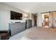 Comfortable bedroom with a TV, dresser, and a barn door leading to the bathroom at 1164 English Sparrow Trl, Highlands Ranch, CO 80129