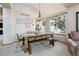 Cozy dining area featuring farmhouse table, chandelier, and backyard views at 1164 English Sparrow Trl, Highlands Ranch, CO 80129