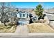 Two-story home featuring attached garage, manicured landscaping, and mountain views at 1164 English Sparrow Trl, Highlands Ranch, CO 80129