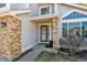 Charming front entrance with brick accents, decorative door wreath, and manicured landscaping at 1164 English Sparrow Trl, Highlands Ranch, CO 80129