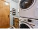 Bright laundry room features a stacked washer and dryer, cabinet storage, and a convenient wall-mounted control panel at 1164 English Sparrow Trl, Highlands Ranch, CO 80129