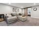 Cozy living room featuring a comfortable sectional sofa, decorative wall art, and sliding barn door at 1164 English Sparrow Trl, Highlands Ranch, CO 80129