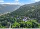 Aerial view of a home nestled in lush greenery surrounded by mountains at 1194 Snyder Mountain Rd, Evergreen, CO 80439