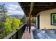 Relaxing back deck with a hot tub, seating area, and stunning mountain views at 1194 Snyder Mountain Rd, Evergreen, CO 80439