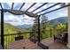 Gorgeous mountain views from the back deck, perfect for relaxing or entertaining guests at 1194 Snyder Mountain Rd, Evergreen, CO 80439