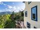 Enjoy the mountain views from the outdoor deck with a custom fire pit area at 1194 Snyder Mountain Rd, Evergreen, CO 80439