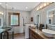 Well-lit bathroom with double vanity, granite countertops, and glass-enclosed shower at 1194 Snyder Mountain Rd, Evergreen, CO 80439