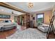 Bright and airy bedroom with wood floors, sitting area, and access to a private balcony at 1194 Snyder Mountain Rd, Evergreen, CO 80439