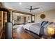Cozy bedroom featuring hardwood floors, a wood-burning stove, and ensuite bathroom at 1194 Snyder Mountain Rd, Evergreen, CO 80439