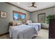 Bright bedroom with twin beds and windows framing beautiful mountain vistas at 1194 Snyder Mountain Rd, Evergreen, CO 80439