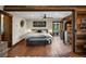 Large main bedroom with hardwood floors, sliding doors to an outdoor patio and rustic wood accents at 1194 Snyder Mountain Rd, Evergreen, CO 80439