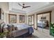 Comfortable bedroom with tray ceiling and large windows and a mirrored closet at 1194 Snyder Mountain Rd, Evergreen, CO 80439