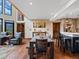 Open floor plan with a dining room featuring wood floors and a modern kitchen at 1194 Snyder Mountain Rd, Evergreen, CO 80439