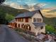 Charming home showcasing an expansive outdoor living area and mountain views at 1194 Snyder Mountain Rd, Evergreen, CO 80439