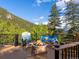 Enjoy the gorgeous Colorado weather with a fire pit, custom seating, and stunning views at 1194 Snyder Mountain Rd, Evergreen, CO 80439
