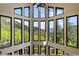 Breathtaking great room with walls of windows showcasing panoramic mountain views at 1194 Snyder Mountain Rd, Evergreen, CO 80439