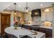Modern kitchen with marble countertop island, updated appliances, and custom cabinets at 1194 Snyder Mountain Rd, Evergreen, CO 80439