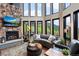 Sun-drenched living room featuring a stone fireplace and mountain views at 1194 Snyder Mountain Rd, Evergreen, CO 80439