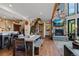 Open-concept living and dining room with stone fireplace, hardwood floors, and mountain views at 1194 Snyder Mountain Rd, Evergreen, CO 80439