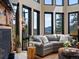 Inviting living room with stone fireplace and large windows offering mountain views at 1194 Snyder Mountain Rd, Evergreen, CO 80439