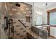 Walk-in shower with tiled walls, a built-in bench, and modern fixtures at 1194 Snyder Mountain Rd, Evergreen, CO 80439