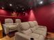 Home theater room with comfortable seating, a projector screen, and ambient lighting at 1194 Snyder Mountain Rd, Evergreen, CO 80439
