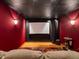 Home theater room with comfortable seating, a projector screen, and ambient lighting at 1194 Snyder Mountain Rd, Evergreen, CO 80439