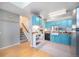 Kitchen with teal cabinets, stainless steel appliances, and a farmhouse sink at 6700 W 11Th Ave # 205, Lakewood, CO 80214