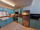 Well-lit kitchen boasts blue cabinets, wood countertops, stainless steel appliances and farmhouse sink at 6700 W 11Th Ave # 205, Lakewood, CO 80214