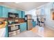 Bright kitchen features teal cabinets, stainless steel appliances, and wood countertops at 6700 W 11Th Ave # 205, Lakewood, CO 80214