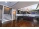 Finished basement featuring a bar, dark cabinetry, wood flooring, and updated lighting at 14193 Double Dutch Cir, Parker, CO 80134
