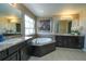 Bathroom boasts dual sinks, granite counters, dark cabinets and a relaxing soaking tub at 14193 Double Dutch Cir, Parker, CO 80134