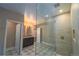 Elegant bathroom featuring a glass walk-in shower with mosaic tile and patterned tile flooring at 14193 Double Dutch Cir, Parker, CO 80134