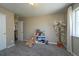 Cozy bedroom with plush carpeting, a decorative tree, and ample natural light at 14193 Double Dutch Cir, Parker, CO 80134