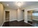 A simple bedroom with dark hardwood floors, a closet, and bright recessed lighting at 14193 Double Dutch Cir, Parker, CO 80134