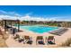 Community swimming pool with plenty of lounge chairs and a shaded seating area at 14193 Double Dutch Cir, Parker, CO 80134