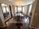 Spacious dining room with a large table, hardwood floors, and decorative mirror and curtains at 14193 Double Dutch Cir, Parker, CO 80134