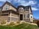 Inviting home exterior showcasing the stone-accented entrance and well-maintained lawn at 14193 Double Dutch Cir, Parker, CO 80134