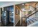 Hallway view with stainless steel appliances and staircase with white railing and hardwood floors at 14193 Double Dutch Cir, Parker, CO 80134