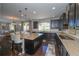 Modern kitchen with a large island, granite countertops, and stainless steel appliances at 14193 Double Dutch Cir, Parker, CO 80134